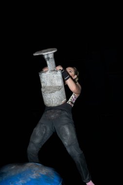 stone that elevates the concept of rural sport. woman from the basque country practicing rural sport of lifting stones