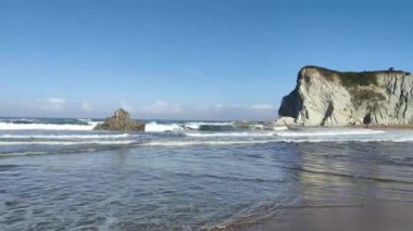 waves breaking on the beach of sopelana in the north of spain