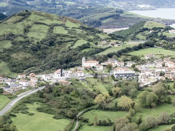 stock image View of a Small Village Nestled Among Green Hills and Countryside