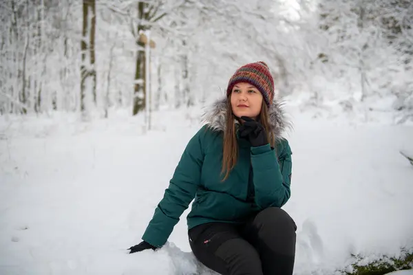 Image Featuring Woman Seated Snow Covered Ground Forest Looking Thoughtful Stock Photo