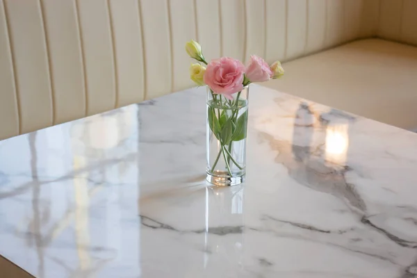Pink rose in vase on the table, stock photo