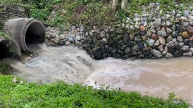 İki beton drenaj kanalından akan fırtına suyu akışı yan yol, stok görüntüleri.