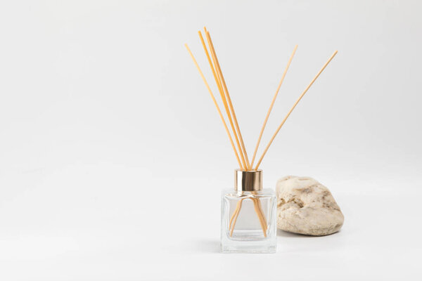 Aroma diffuser and sea stone on a gray background. Place for text