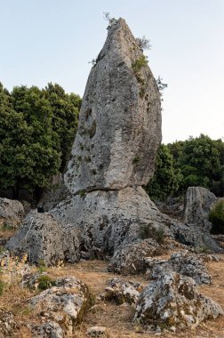 Araklis, a huge monolith near the village of Anogi at the island of Ithaka in Epirus, Greece clipart