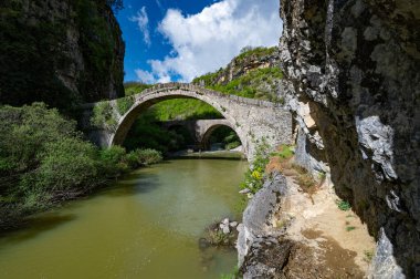 View of the traditional stone Bridge of Noutsos or Kokkoros in Epirus, Greece in Sprin clipart