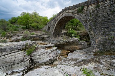 View of the traditional stone Bridge of Greci in Epirus, Greece in Sprin clipart