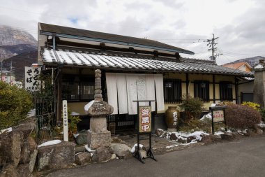 Yufuin,Japan - January 5,2023 : The vintage shopping on main street of Yufuin after snow fall in winter