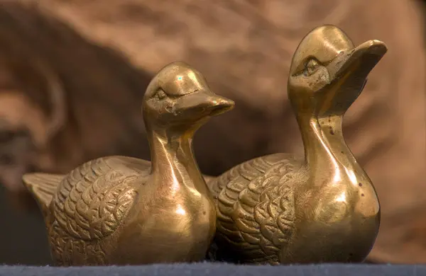 close - up of two bronze ducks on the table