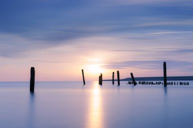 De Cocksdorp, Texel, Hollanda 'nın eski limanı yakınlarındaki Haventje van Sil (Sil' in limanı) adlı çamurlu düzlüklerde gün batımı manzarası)