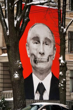 Riga, Latvia, december 14, 2022: Red big banner with Putin's skull hung at Medicine History Museum in front of Russian embassy                               