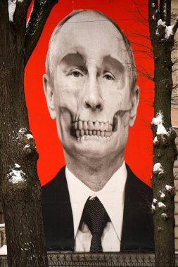 Riga, Latvia, december 14, 2022: Red big banner with Putin's skull hung at Medicine History Museum in front of Russian embassy                               