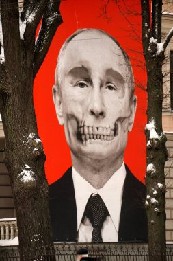 Riga, Latvia, december 14, 2022: Red big banner with Putin's skull hung at Medicine History Museum in front of Russian embassy                               