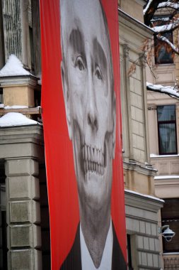 Riga, Latvia, december 14, 2022: Red big banner with Putin's skull hung at Medicine History Museum in front of Russian embassy                               