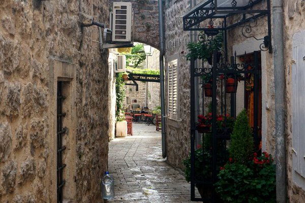 BUDVA, MONTENEGRO - JUNE 25, 2023: the old town of Budva, Montenegro, view narrow street, cafe and courtyards
