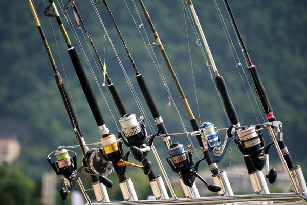 Budva, Montenegro - June 25, 2023: Boats with many fishing rods on board. Fishing services for tourists, Budva                               