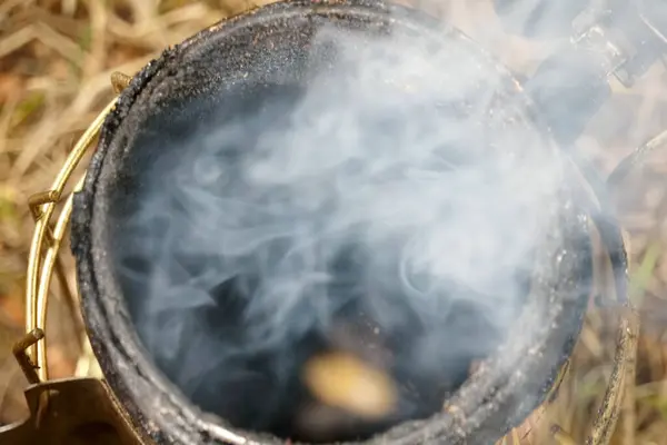 stock image   Close up of a beekeepers smoking equipment with smoke and fire coming out of the nozzle                             