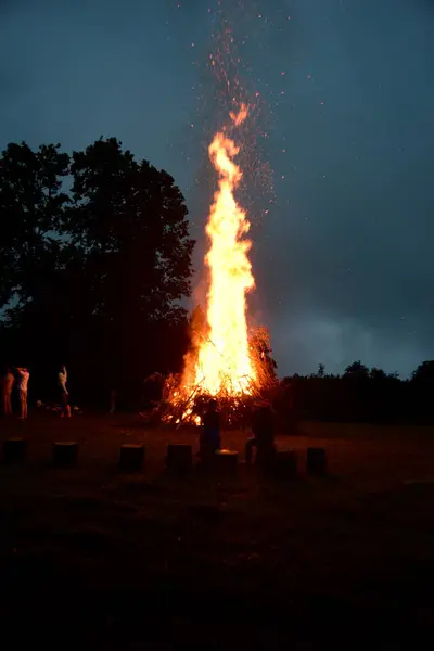 stock image Large Midsummer bonfire at night in Latvia. Burning bonfire with dark background