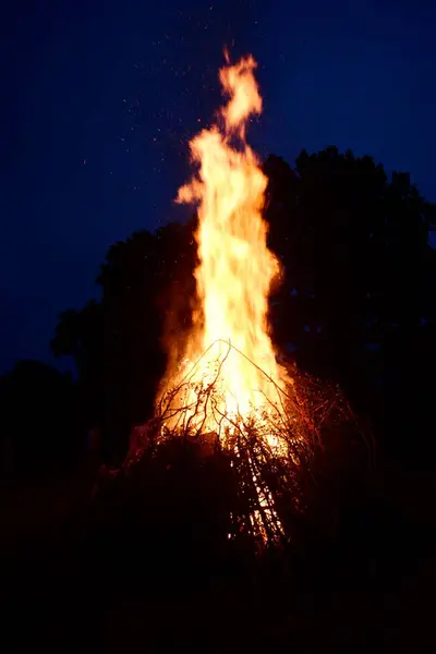 stock image Large Midsummer bonfire at night in Latvia. Burning bonfire with dark background