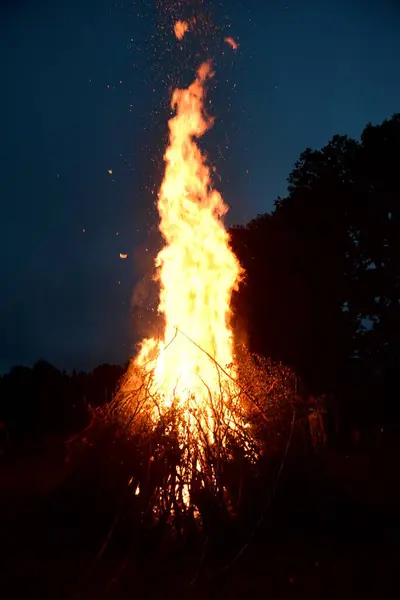 stock image Large Midsummer bonfire at night in Latvia. Burning bonfire with dark background