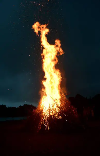 stock image Large Midsummer bonfire at night in Latvia. Burning bonfire with dark background