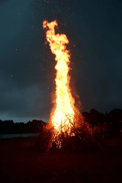 stock image Large Midsummer bonfire at night in Latvia. Burning bonfire with dark background