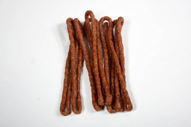 Kabanos dried sausages on white background. Polish thin, long, dry sausage clipart