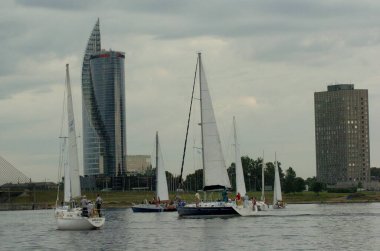 Riga, Latvia 05 August, 2005: Sailing competition in Riga, river Daugava. Yachts on the water in the evening light clipart