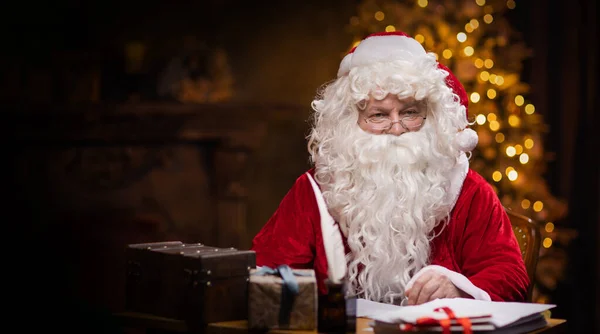 Workplace Santa Claus Cheerful Santa Working While Sitting Table Fireplace — Stock Photo, Image