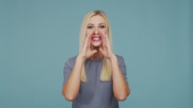 Stüdyodaki güzel sarışın kız. Mavi arka planda sevimli ve duygusal bir kızın portresi.