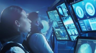 Yörünge istasyonunda uzay giysileri içinde bir astronot ekibi. Uzay gemisine pilotluk eden bir kozmonot mürettebatı. Uzayda kadın ve erkek. Galaktik seyahat ve bilim konsepti.
