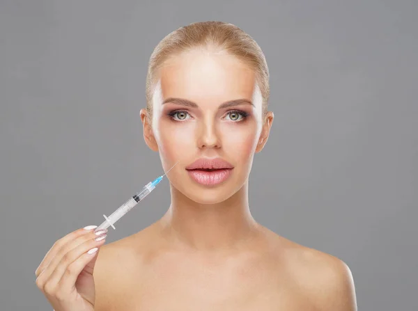 Beauty injection in a face of a young woman. Plastic surgery, skin lifting and aesthetic medicine concept.