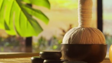 Spa background. Candles, flowers, massaging stones and herbal balls. The concept of massage, oriental therapy, wellbeing and meditation.
