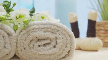 Spa background. Candles, flowers, massaging stones and herbal balls. The concept of massage, oriental therapy, wellbeing and meditation.