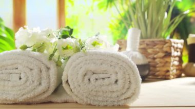 Spa background. Candles, flowers, massaging stones and herbal balls. The concept of massage, oriental therapy, wellbeing and meditation.
