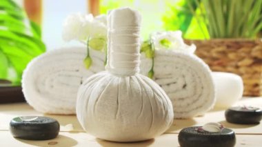 Spa background. Candles, flowers, massaging stones and herbal balls. The concept of massage, oriental therapy, wellbeing and meditation.