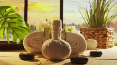 Spa background. Candles, flowers, massaging stones and herbal balls. The concept of massage, oriental therapy, wellbeing and meditation.