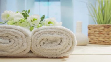 Spa background. Candles, flowers, massaging stones and herbal balls. The concept of massage, oriental therapy, wellbeing and meditation.