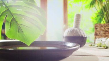 Spa background. Candles, flowers, massaging stones and herbal balls. The concept of massage, oriental therapy, wellbeing and meditation.