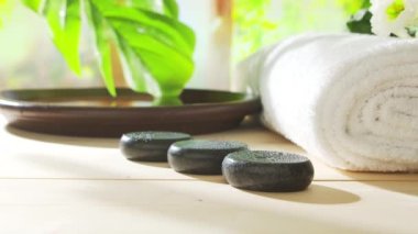 Spa background. Candles, flowers, massaging stones and herbal balls. The concept of massage, oriental therapy, wellbeing and meditation.