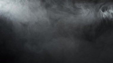 Smoke over black background. Fog or steam abstract dark texture pattern. Black background.