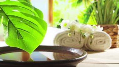 Spa background. Candles, flowers, massaging stones and herbal balls. The concept of massage, oriental therapy, wellbeing and meditation.