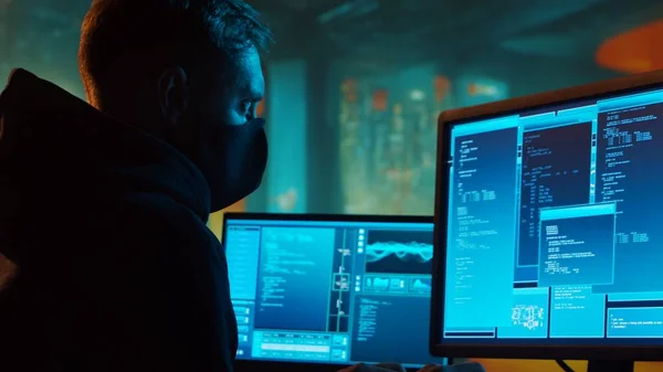 stock image Computer Hacker in Hoodie. Obscured Dark Face. Hacker Attack, Virus Infected Software, Dark Web and Cyber Security concept.
