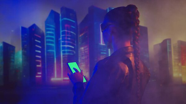 Portrait of cyberpunk girl. Beautiful young woman on the background of city scyscrapers. Futuristic concept.