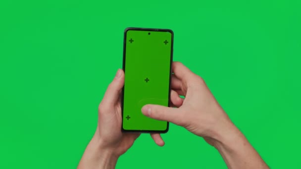 Male Hand Holding Smartphone Vertical Green Chroma Key Screen Isolated — Wideo stockowe