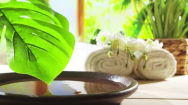 Spa background. Candles, flowers, massaging stones and herbal balls. The concept of massage, oriental therapy, wellbeing and meditation.