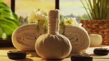 Spa background. Candles, flowers, massaging stones and herbal balls. The concept of massage, oriental therapy, wellbeing and meditation.
