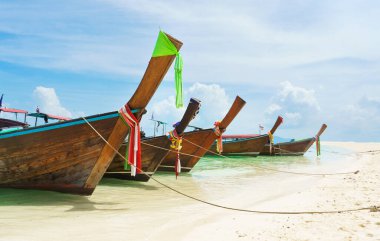 Thai traditional wooden longtail boat and beautiful sand beach in Thailand. The concept of traveling.