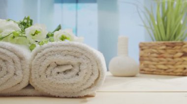 Spa background. Candles, flowers, towels and herbal balls. The concept of massage, oriental therapy, wellbeing and meditation.