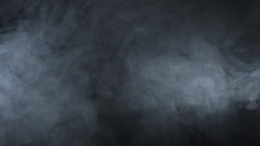 Smoke over black background. Fog or steam abstract dark texture pattern. Black background.