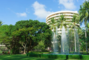 The building of the hotel in the Asian garden. Exotic plants and flowers, beautiful landscape. Vacation concept.